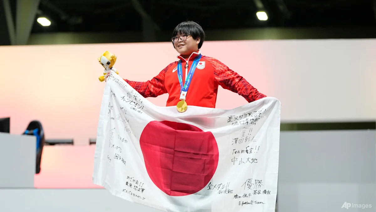 Yuki Kurihara merayakan kemenangan medali emas esports Puyo Puyo Champions di Asian Games Nagoya